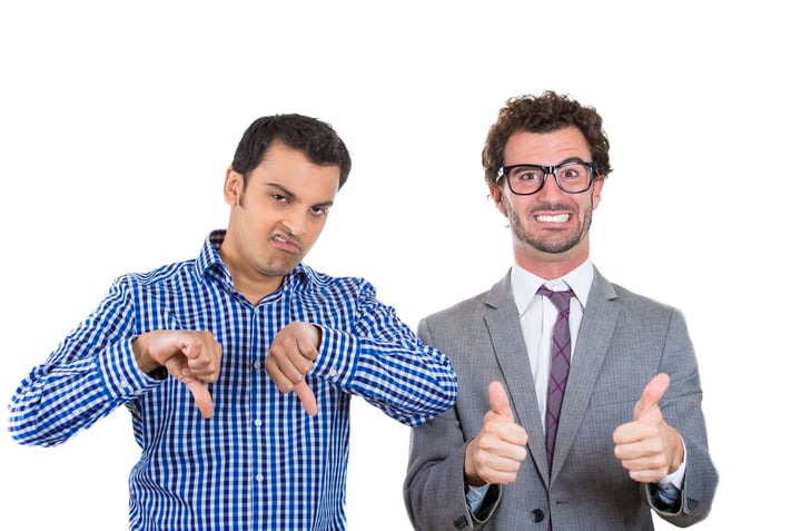 A portrait of two co-workers, a wall street businessman and a main street worker, one being negative and angry, the second one positive and optimistic, isolated on a white background. World polarity.jpeg